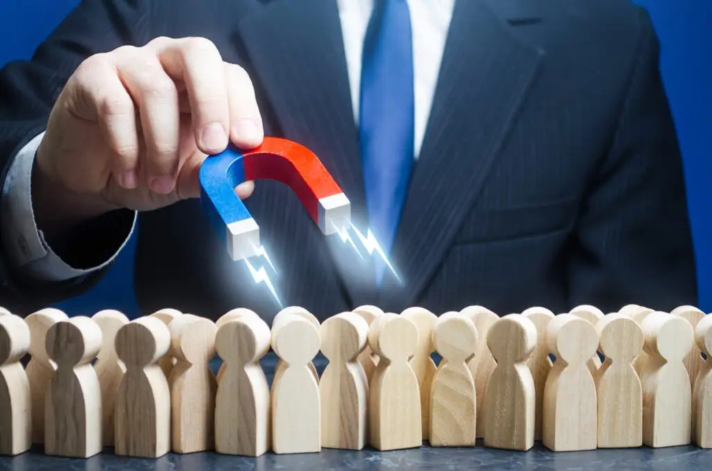 magnet in hand attracting leads